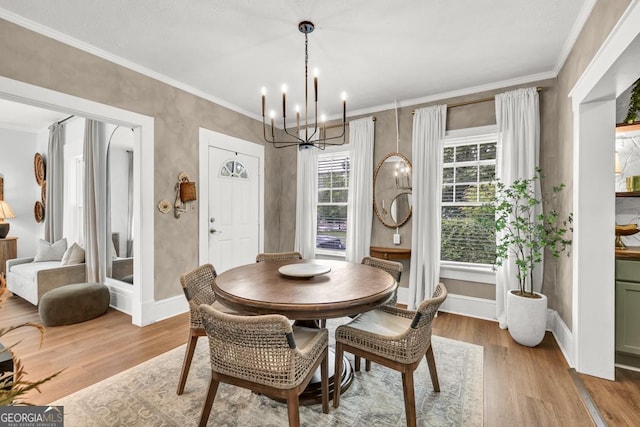 575 E Main St, Buford, GA 30518 - dining area with a chandelier, wood finished floors, ornamental molding, and baseboards
