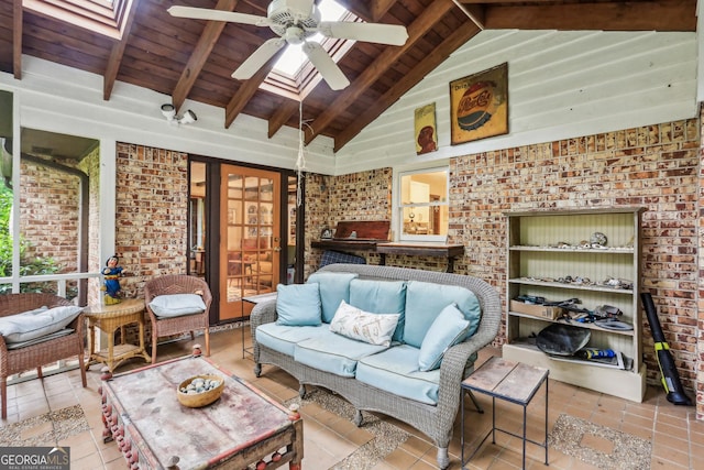 2700 Regency Dr E, Tucker, GA 30084 - living area featuring ceiling fan, tile patterned flooring, wooden ceiling with exposed beams, high vaulted ceiling, and a skylight
