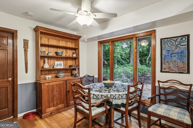2700 Regency Dr E, Tucker, GA 30084 - dining room featuring a ceiling fan, light wood-type flooring, and wainscoting