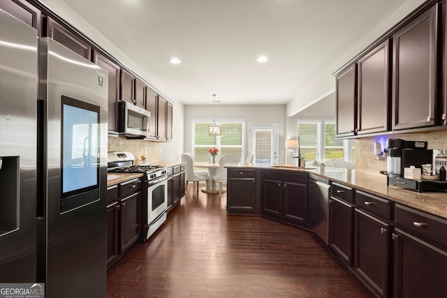 4965 Brierstone Dr, Alpharetta, GA 30004 - kitchen with stainless steel appliances, recessed lighting, dark brown cabinets, dark wood-style flooring, and backsplash