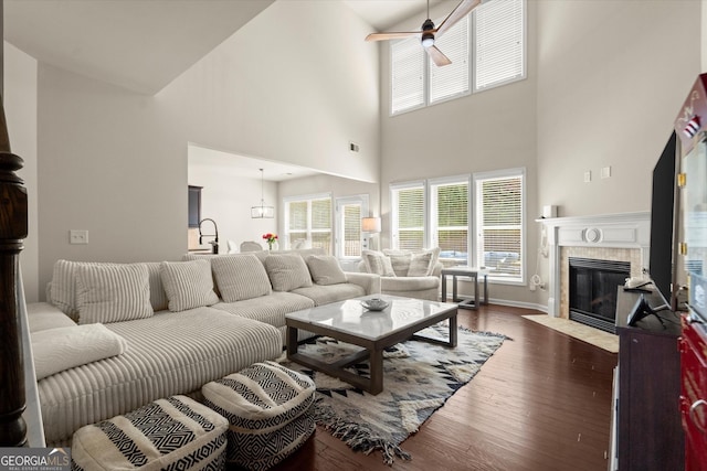 4965 Brierstone Dr, Alpharetta, GA 30004 - living room featuring ceiling fan, a tile fireplace, dark wood-style floors, a towering ceiling, and plenty of natural light