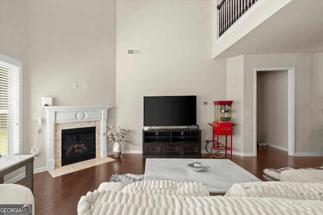 4965 Brierstone Dr, Alpharetta, GA 30004 - living room featuring a high ceiling, wood finished floors, and a tiled fireplace