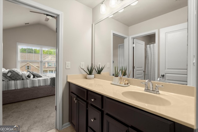 4965 Brierstone Dr, Alpharetta, GA 30004 - bathroom with vanity, lofted ceiling, and connected bathroom