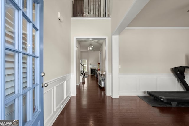 4965 Brierstone Dr, Alpharetta, GA 30004 - foyer entrance featuring wainscoting, dark wood-type flooring, ornamental molding, and a decorative wall