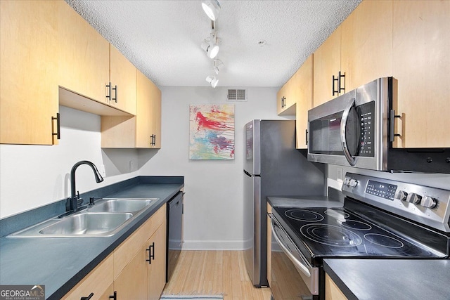 387 Ralph Mcgill Blvd NE Unit K, Atlanta, GA 30312 - kitchen featuring appliances with stainless steel finishes, dark countertops, light wood finished floors, a textured ceiling, and light brown cabinetry