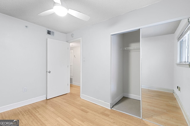 387 Ralph Mcgill Blvd NE Unit K, Atlanta, GA 30312 - unfurnished bedroom with light wood-type flooring, a closet, a textured ceiling, and a ceiling fan