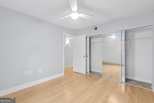 387 Ralph Mcgill Blvd NE Unit K, Atlanta, GA 30312 - unfurnished bedroom with a textured ceiling, light wood-style flooring, a closet, and a ceiling fan