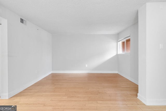 387 Ralph Mcgill Blvd NE Unit K, Atlanta, GA 30312 - spare room featuring a textured ceiling and light wood-type flooring