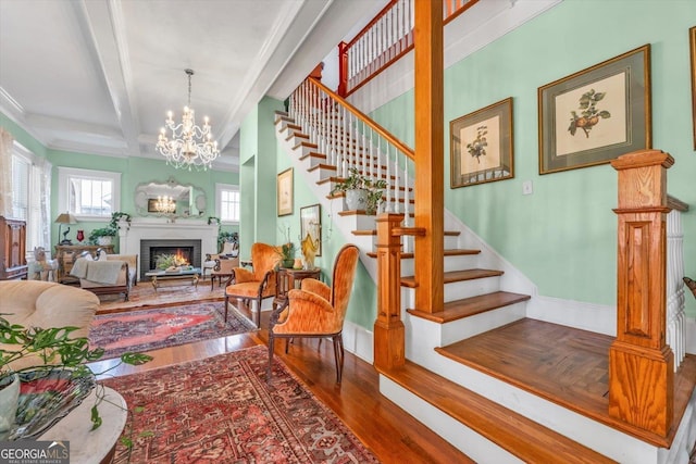 403 E Robert Toombs Ave, Washington, GA 30673 - stairs with wood finished floors, a chandelier, beam ceiling, a fireplace, and baseboards