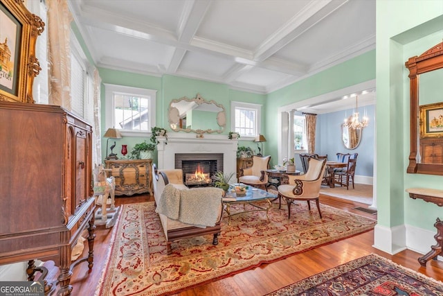 403 E Robert Toombs Ave, Washington, GA 30673 - living room featuring wood finished floors, beamed ceiling, a lit fireplace, a chandelier, and coffered ceiling