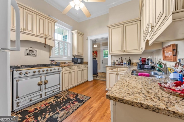 403 E Robert Toombs Ave, Washington, GA 30673 - kitchen featuring cream cabinetry, a sink, ceiling fan, light wood-type flooring, and healthy amount of natural light