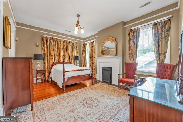 403 E Robert Toombs Ave, Washington, GA 30673 - bedroom with wood finished floors and a brick fireplace