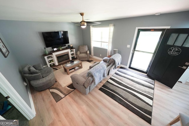 531 Beaver Pond Rd, Carrollton, GA 30117 - living area featuring wood finished floors, a ceiling fan, and a glass covered fireplace