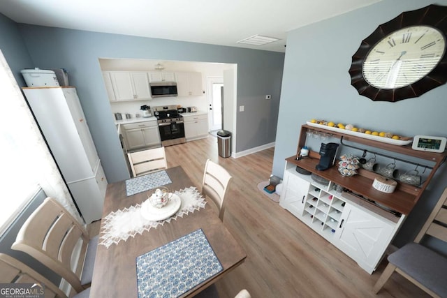 531 Beaver Pond Rd, Carrollton, GA 30117 - dining area with light wood finished floors and baseboards