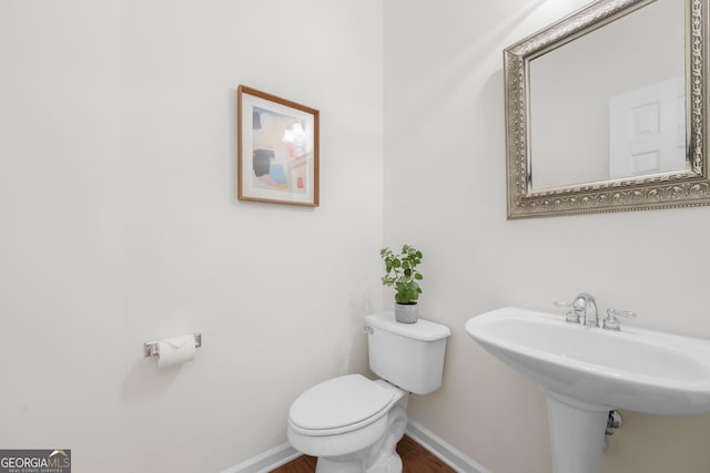 3655 Chattahoochee Summit Dr SE Unit 16, Atlanta, GA 30339 - half bath featuring toilet, baseboards, wood finished floors, and a sink