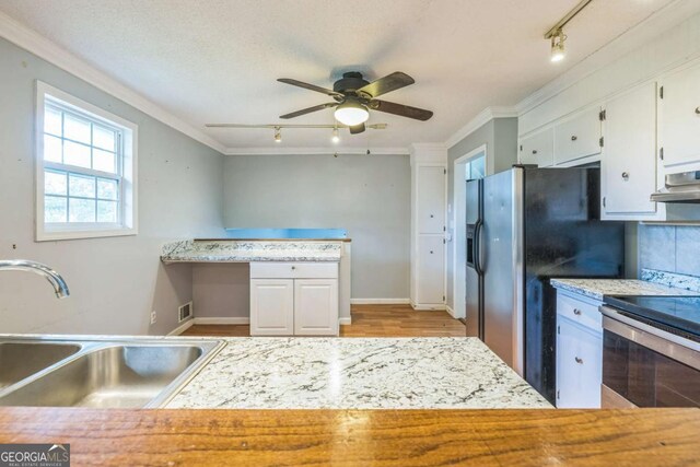 4572 Colonial Rd, Augusta, GA 30907 - kitchen featuring track lighting, stainless steel appliances, a ceiling fan, light countertops, and crown molding