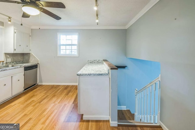 4572 Colonial Rd, Augusta, GA 30907 - kitchen with dishwasher, rail lighting, ceiling fan, white cabinets, and ornamental molding