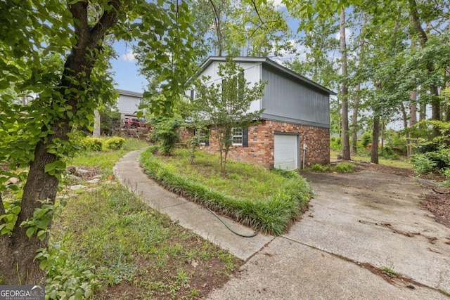 4572 Colonial Rd, Augusta, GA 30907 - view of side of property featuring brick siding, driveway, and an attached garage