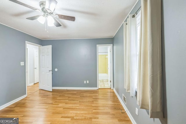 4572 Colonial Rd, Augusta, GA 30907 - unfurnished bedroom with light wood-style floors, connected bathroom, and ceiling fan