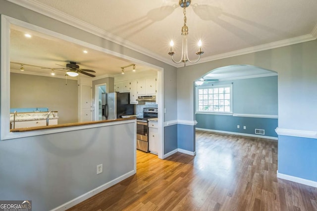 4572 Colonial Rd, Augusta, GA 30907 - kitchen with appliances with stainless steel finishes, a ceiling fan, arched walkways, under cabinet range hood, and crown molding