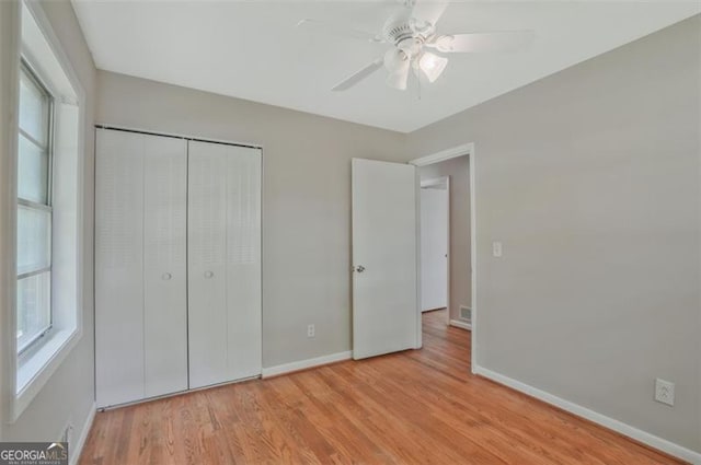 622 Sheffield Rd, Norcross, GA 30071 - unfurnished bedroom with baseboards, multiple windows, and light wood-style floors