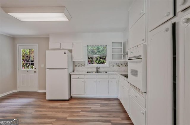 622 Sheffield, Norcross, GA 30071 - kitchen with white appliances, white cabinets, light wood finished floors, light countertops, and decorative backsplash