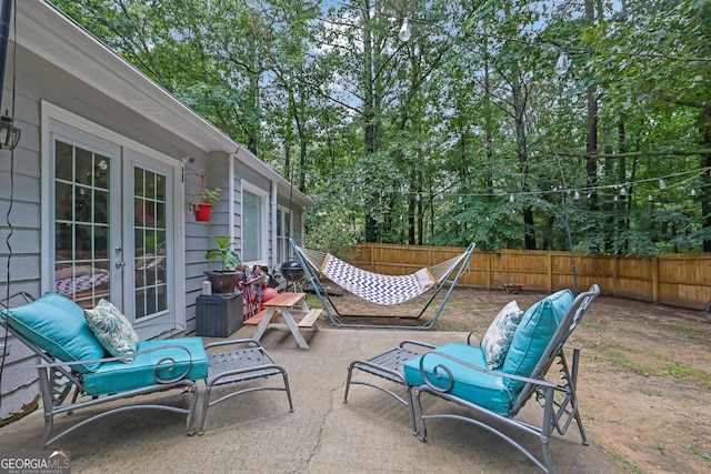 4180 Gables Pl, Buford, GA 30519 - fenced backyard with french doors, a patio area, and view of wooded area