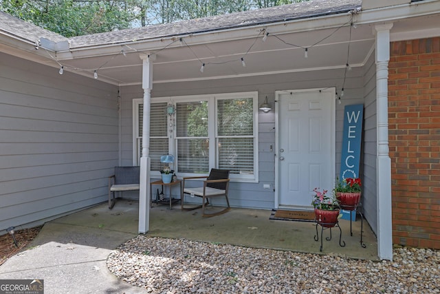 4180 Gables Pl, Buford, GA 30519 - entrance to property featuring brick siding, roof with shingles, and covered porch