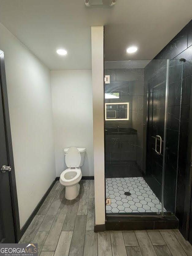 185 Glenrose Cir SW, Atlanta, GA 30354 - full bath with wood tiled floors, a shower stall, and recessed lighting