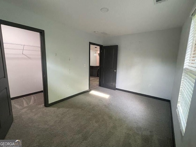 185 Glenrose Cir SW, Atlanta, GA 30354 - unfurnished bedroom with carpet, a walk in closet, and a closet