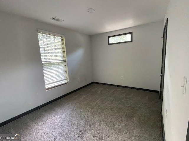 185 Glenrose Cir SW, Atlanta, GA 30354 - spare room with dark colored carpet and baseboards