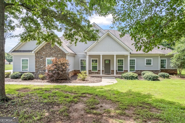 104 Bonny Oaks Dr, Lagrange, GA 30240 - craftsman-style home with stone siding, a front yard, covered porch, and roof with shingles