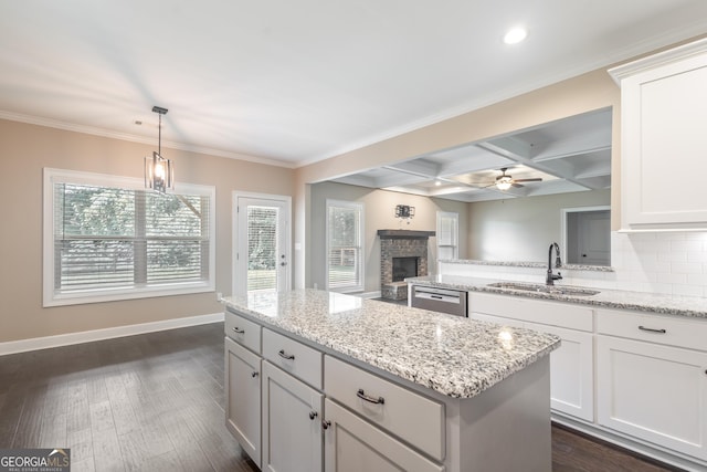 104 Bonny Oaks Dr, Lagrange, GA 30240 - kitchen with stainless steel dishwasher, coffered ceiling, a center island, ceiling fan, and a fireplace with raised hearth