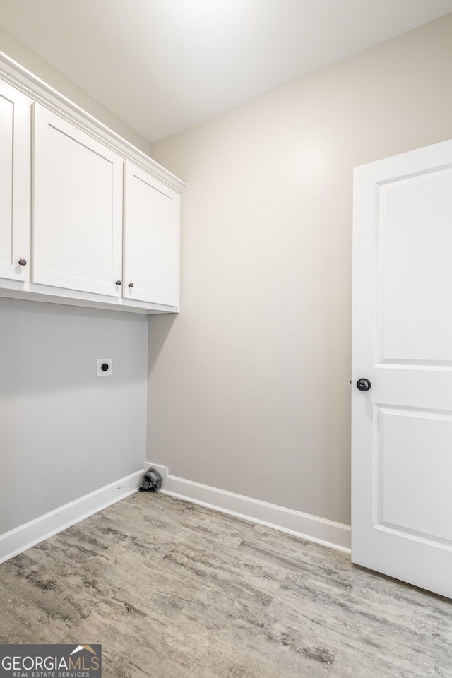 104 Bonny Oaks Dr, Lagrange, GA 30240 - laundry area with wood finished floors, hookup for an electric dryer, and cabinet space