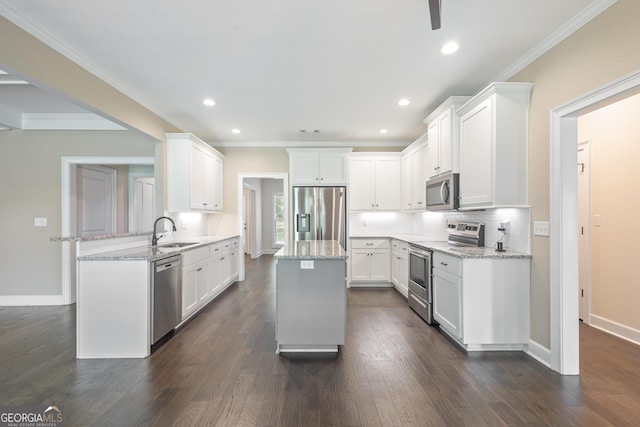 104 Bonny Oaks Dr, Lagrange, GA 30240 - kitchen with appliances with stainless steel finishes, a peninsula, light stone countertops, dark wood finished floors, and white cabinetry