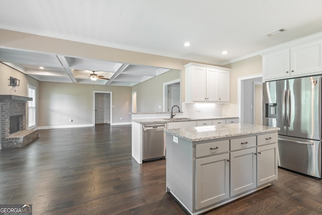 104 Bonny Oaks Dr, Lagrange, GA 30240 - kitchen with stainless steel appliances, open floor plan, a kitchen island, a ceiling fan, and a peninsula