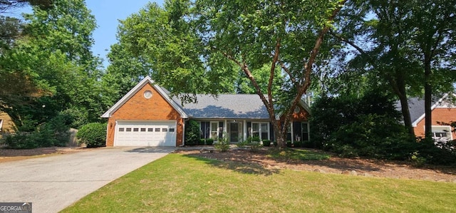 2123 Condor Dr, Lawrenceville, GA 30044 - view of front facade with driveway, a garage, a front yard, and brick siding