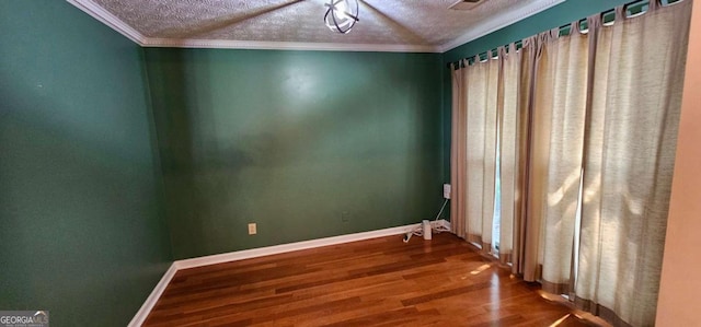 2123 Condor Dr, Lawrenceville, GA 30044 - spare room with a textured ceiling, wood finished floors, crown molding, and baseboards