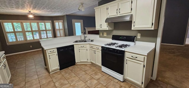 2123 Condor Dr, Lawrenceville, GA 30044 - kitchen with gas range, dishwasher, a sink, under cabinet range hood, and a peninsula