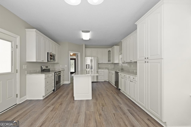 515 Youmans Rd, Midway, GA 31320 - kitchen featuring stainless steel appliances, white cabinets, light wood-style floors, and a sink