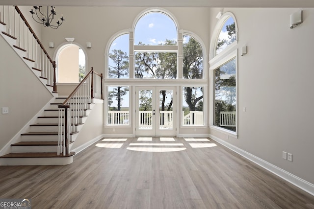 515 Youmans Rd, Midway, GA 31320 - foyer entrance with a towering ceiling, stairs, wood finished floors, baseboards, and french doors