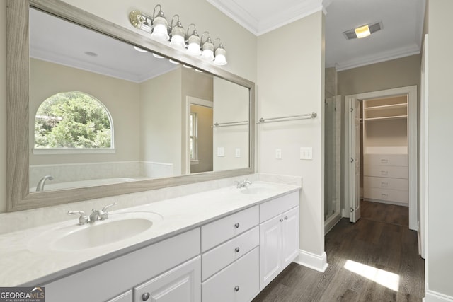 515 Youmans Rd, Midway, GA 31320 - full bath featuring wood finished floors, double vanity, ornamental molding, a bath, and baseboards