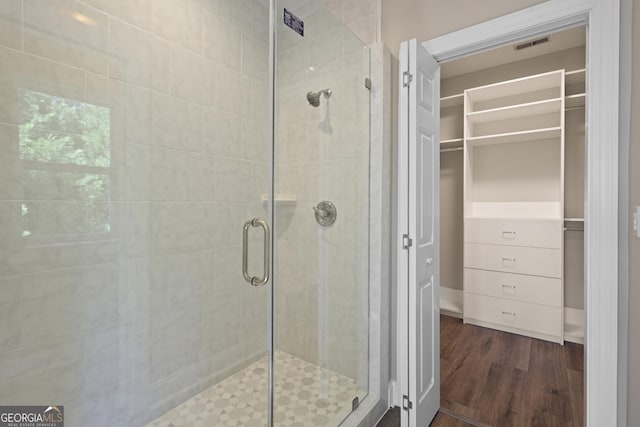 515 Youmans Rd, Midway, GA 31320 - full bathroom with a shower stall, wood finished floors, and a spacious closet