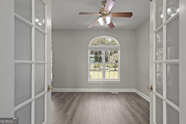 515 Youmans Rd, Midway, GA 31320 - unfurnished room with wood finished floors, baseboards, a textured ceiling, and a ceiling fan