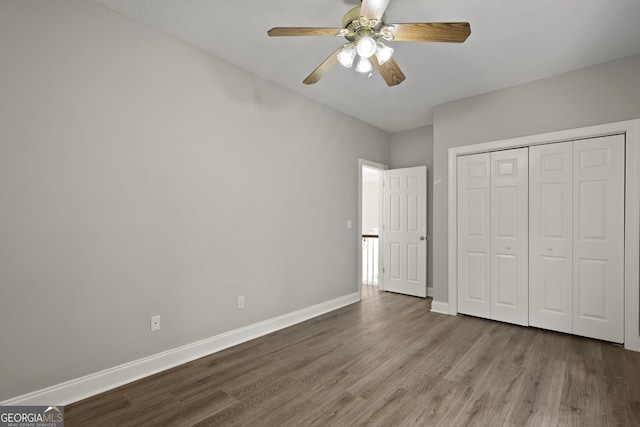515 Youmans Rd, Midway, GA 31320 - unfurnished bedroom featuring wood finished floors, baseboards, a closet, and ceiling fan