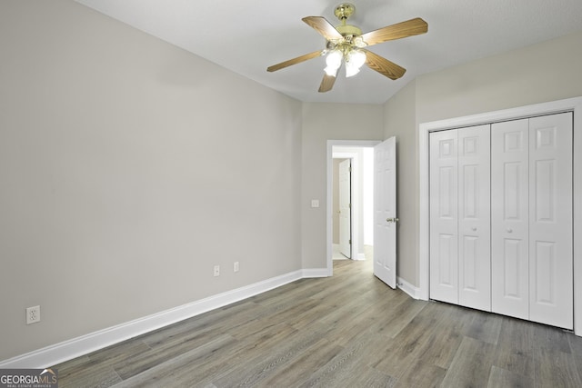 515 Youmans Rd, Midway, GA 31320 - unfurnished bedroom with wood finished floors, baseboards, a closet, and ceiling fan