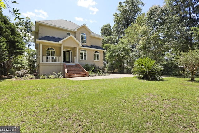 515 Youmans Rd, Midway, GA 31320 - view of front facade featuring stucco siding, stairway, a front lawn, and a porch
