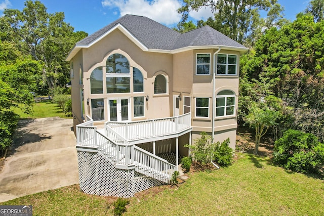 515 Youmans Rd, Midway, GA 31320 - back of house with stucco siding, a lawn, french doors, and stairway