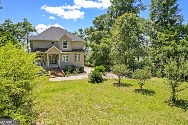 515 Youmans Rd, Midway, GA 31320 - traditional-style house featuring a front yard, a shingled roof, and stairs