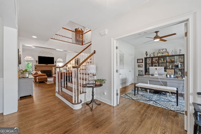 1280 Trinity Church Rd, Canton, GA 30115 - foyer featuring wood finished floors, ceiling fan, ornamental molding, a fireplace, and stairway